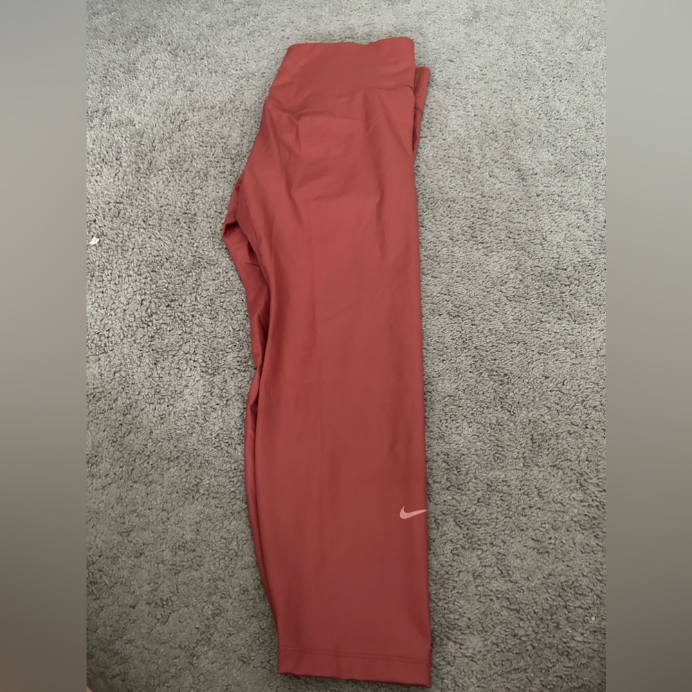 Nike Women's Mid-rise faux leather leggings in canyon Rust